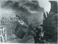 Red army soldiers raising the soviet flag on the roof of the reichstag berlin germany.jpg
